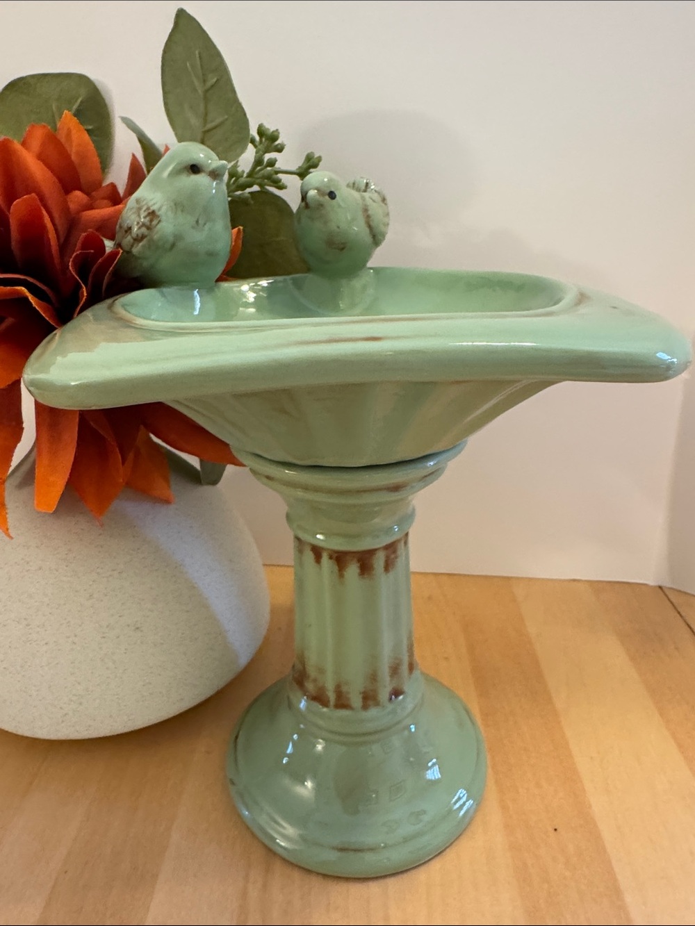 Charming sage green ceramic tabletop birdbath featuring two birds
